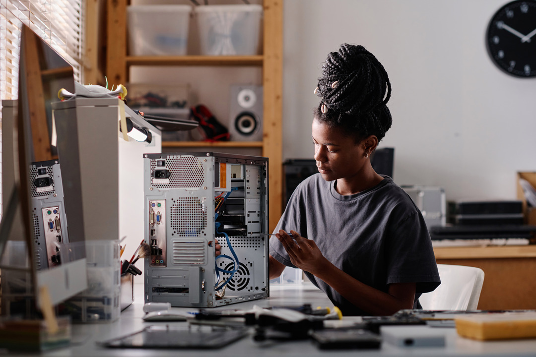 Woman fixes computer tower